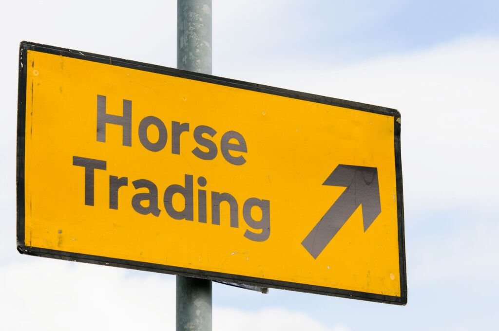 A sign says Horse Traiding with an arrow pointing in one direction